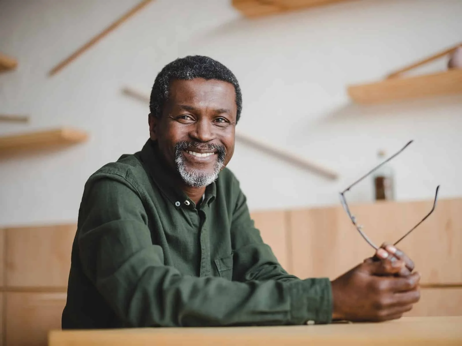 Man-smiling-holding-his-glasses by Hill Dental Acquisitions LLC, DBA Smile On Dental Studio in Richmond Heights, MO